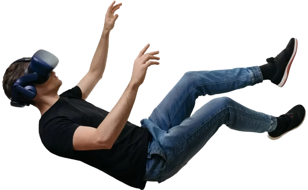 Young adult male in a falling pose wearing a black t-shirt and blue jeans against a plain white background